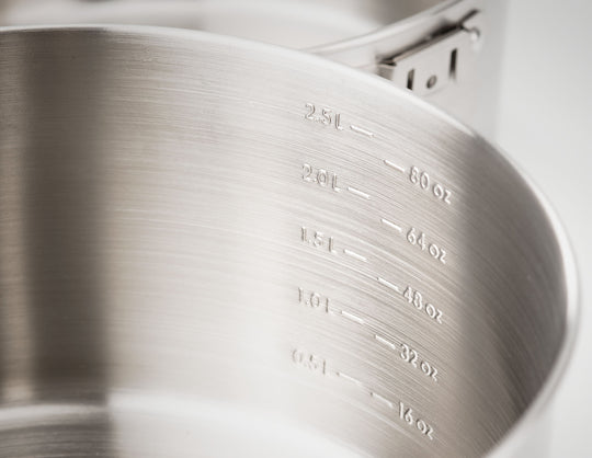 Close-up image of the interior of a GSI Outdoors pot, showcasing etched measurement markings in liters and ounces, against a clean background.
