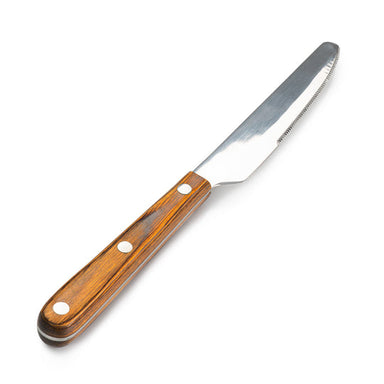 Image of stainless steel serrated table knife with wooden riveted handle, angled front view on white background.