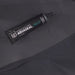 Image of Gear Aid Aquaseal Neo contact cement tube placed on dark neoprene fabric with visible seam and tear, angled top view on a dark background.