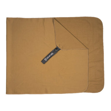 Image of Gear Aid cooling towel laid flat and unfolded, tan fabric with corner snap and logo tag visible, top-down view on white background.