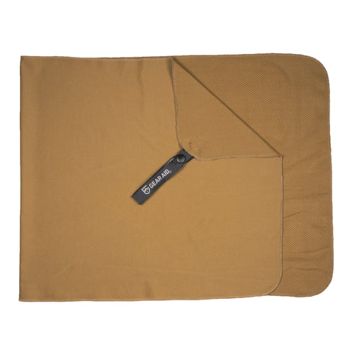 Image of Gear Aid cooling towel laid flat and unfolded, tan fabric with corner snap and logo tag visible, top-down view on white background.