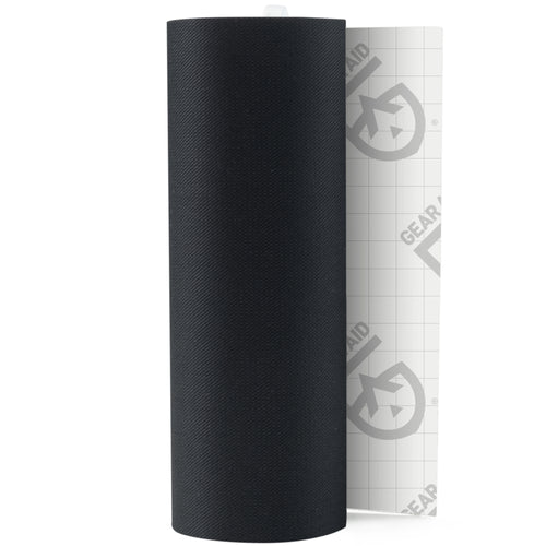 Image of Gear Aid Tenacious Tape black fabric repair roll with peel-off backing partially visible, upright view showing textured material on white background.