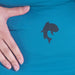 Image of a black fish-shaped adhesive repair patch applied to blue outdoor fabric, close-up side view with a hand showing patch scale and placement.