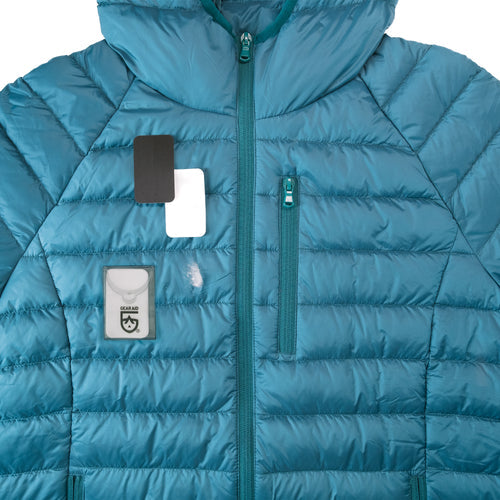 Image of Gear Aid Tenacious Tape Mini Patches shown repairing a tear on a blue down jacket, with compact patch case and pre-cut patches displayed, front view on white background.