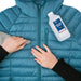 Image of blue down jacket being cleaned with cloth and isopropyl alcohol before repair, preparation step shown for applying Gear Aid Tenacious Tape Mini Patches on white background.