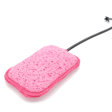 Image of Geyser Systems pink scrub sponge attachment with porous texture and black hose connection, angled close-up view on white background.