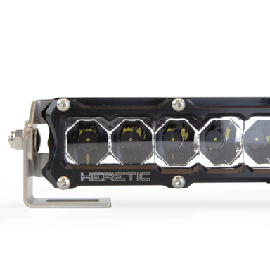 Image of a Heretic brand LED light bar with a black housing and multiple individual LED lights, showing a close-up of the light array and part of the mounting bracket, set against a white background