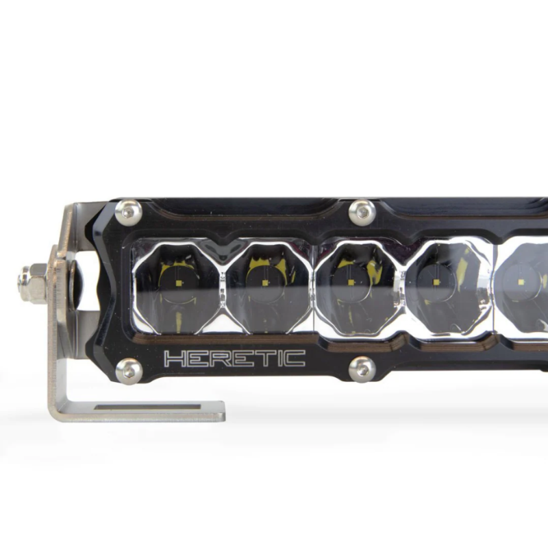 Image of a Heretic brand LED light bar with a black housing and multiple individual LED lights, showing a close-up of the light array and part of the mounting bracket, set against a white background