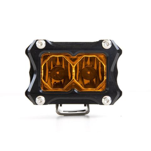 Image of a single rectangular off-road LED light with a black housing, silver bolts, and amber-colored lenses, positioned centrally on a white background.