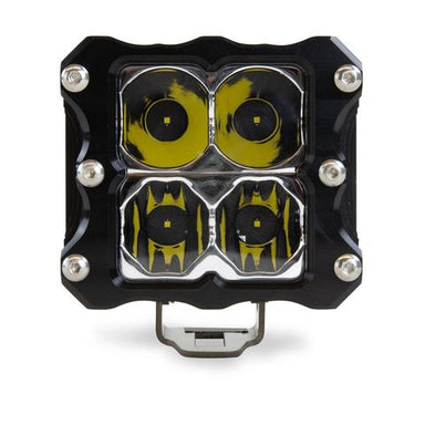 Image of a single square off-road LED light with a black housing, silver bolts, and four yellow-tinted lenses, positioned centrally on a white background.