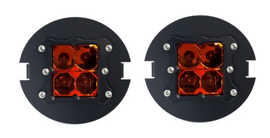 Pair of round black off-road lights with amber lenses, featuring four square LED lights each, shown on a white background.