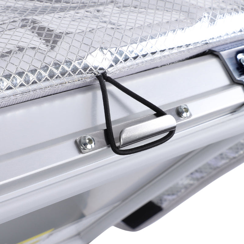 Image of a close-up on the silver latch and bungee cord of an ICECO portable refrigerator/freezer, with a metallic diamond-patterned lid lining visible