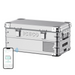 Image of a silver ICECO portable refrigerator/freezer with chrome accents, shown from an angled front and side view, with a smartphone displaying the ICECO app connected wirelessly to the cooler, on a white background