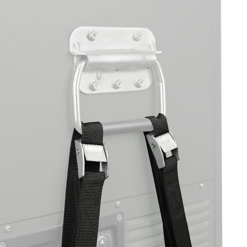 A close-up image showing two black securing straps with metal buckles attached to the silver handle of a gray portable refrigerator, highlighting the mechanism for securing the cooler to a slide