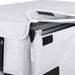 Image of a close-up on the light gray protective cover of an ICECO portable refrigerator, showing an unzipped section revealing a silver, textured interior lining and part of the black refrigerator unit