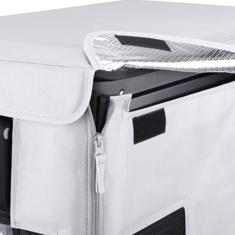 Image of a close-up on the light gray protective cover of an ICECO portable refrigerator, showing an unzipped section revealing a silver, textured interior lining and part of the black refrigerator unit
