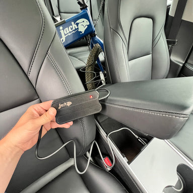 Image of the JackRabbit 12V Ultra Portable Charger, featuring the black power brick connected to a cable with a DC barrel jack and a 12V cigarette lighter plug.