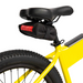 Image of black fabric saddlebag with red reflective strip securely mounted under the seat of a yellow bicycle, close-up rear side view on a white background.
