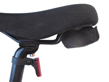 Image of bicycle saddle with attached padded shoulder carry sling and rear reflector, close-up side view on white background.