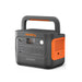 Image of Jackery Explorer 1000 portable power station with built-in carry handle, front control panel and side ventilation visible, dark gray housing with orange accents, angled front and side view on white background.