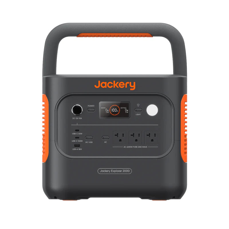 Image of Jackery Explorer 2000 portable power station with integrated handle, black and orange casing, front control panel with LCD display, AC and USB ports, straight-on front view on white background.