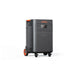 Image of Jackery Explorer 5000 Plus portable power station with built-in wheels and pull handle, black casing with front control panel and multiple outlets, angled front and side view on white background.