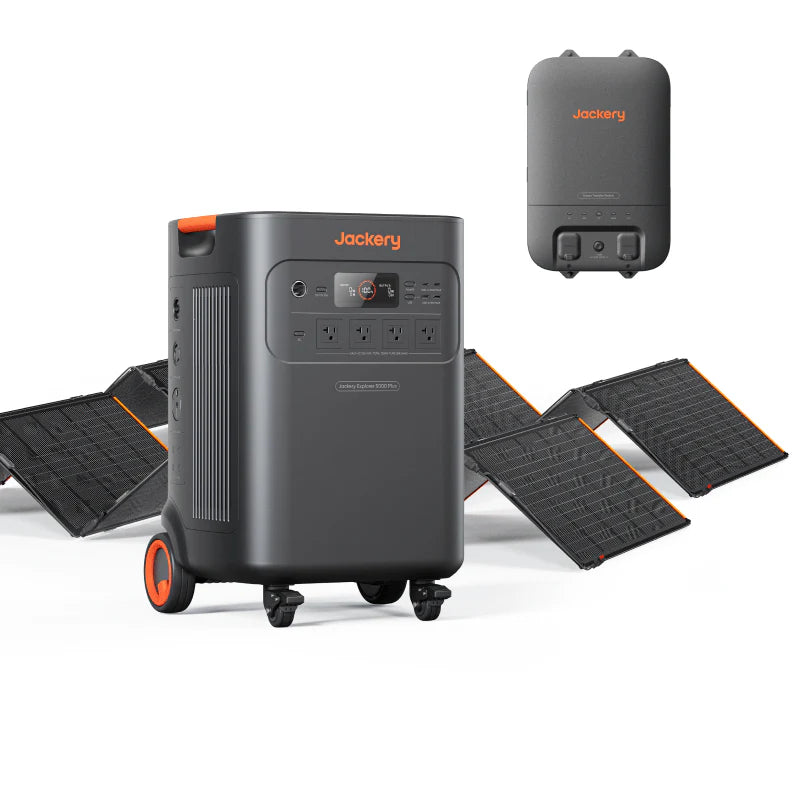 Image of Jackery Explorer 5000 Plus portable power station with wheels paired with foldable solar panels and a smart transfer switch, black and orange design, angled front view on a white background.