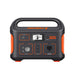 Image of Jackery Explorer 500 portable power station with integrated carry handle, front-facing view showing LCD display, AC outlet, USB and DC ports, black and orange casing on a white background.