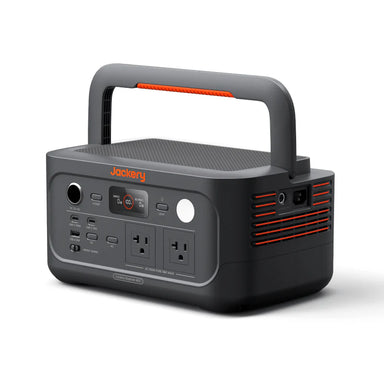 Image of Jackery Explorer 600 portable power station with integrated carry handle, front control panel and side ventilation visible, dark gray housing with orange accents, angled front and side view on white background.