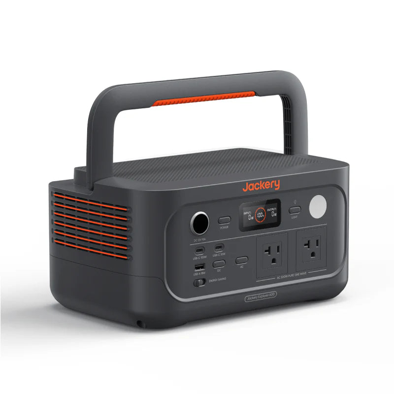 Image of Jackery Explorer 600 portable power station with built-in carry handle, front control panel and side ventilation grills visible, dark gray body with orange accents, angled front and side view on white background.