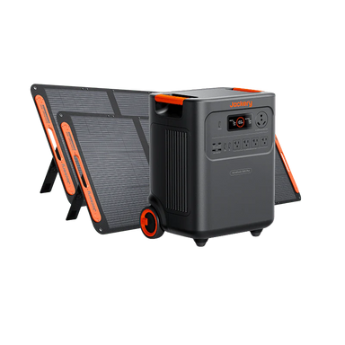 Image of Jackery HomePower 3600 portable power station with wheels paired with foldable solar panels, black and orange design, angled front and side view showing unit positioned in front of solar panels on a white background.