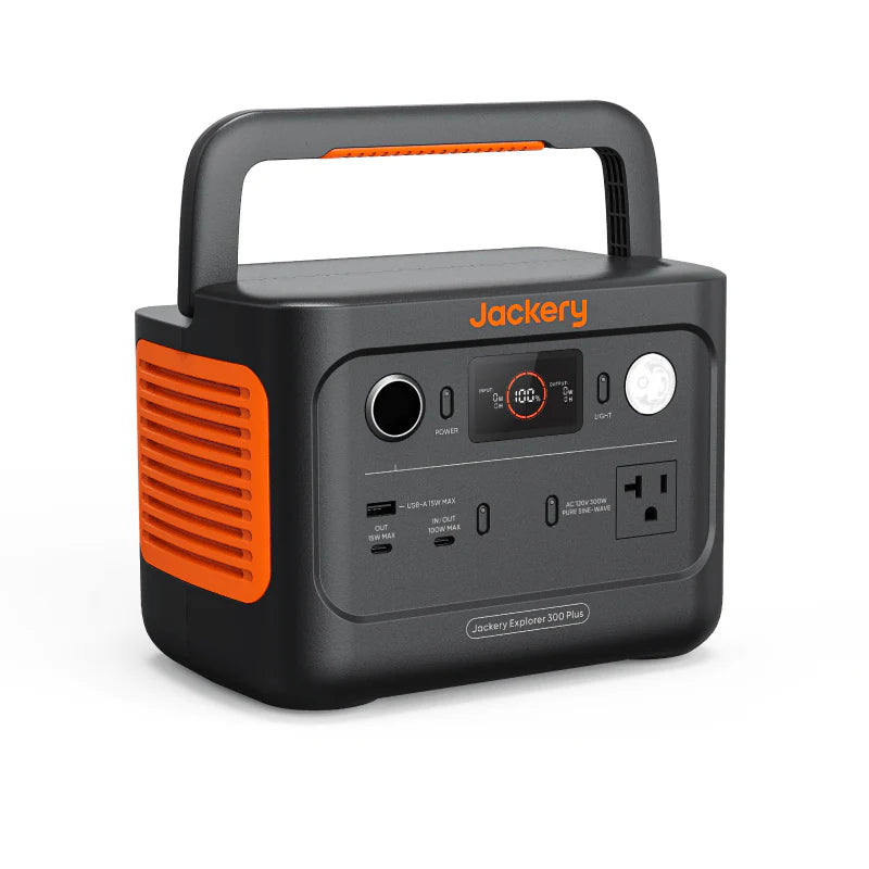 Image of a Jackery Explorer 300 Plus portable power station with integrated handle, black and gray housing with orange accents and front control panel, angled front and side view on white background.