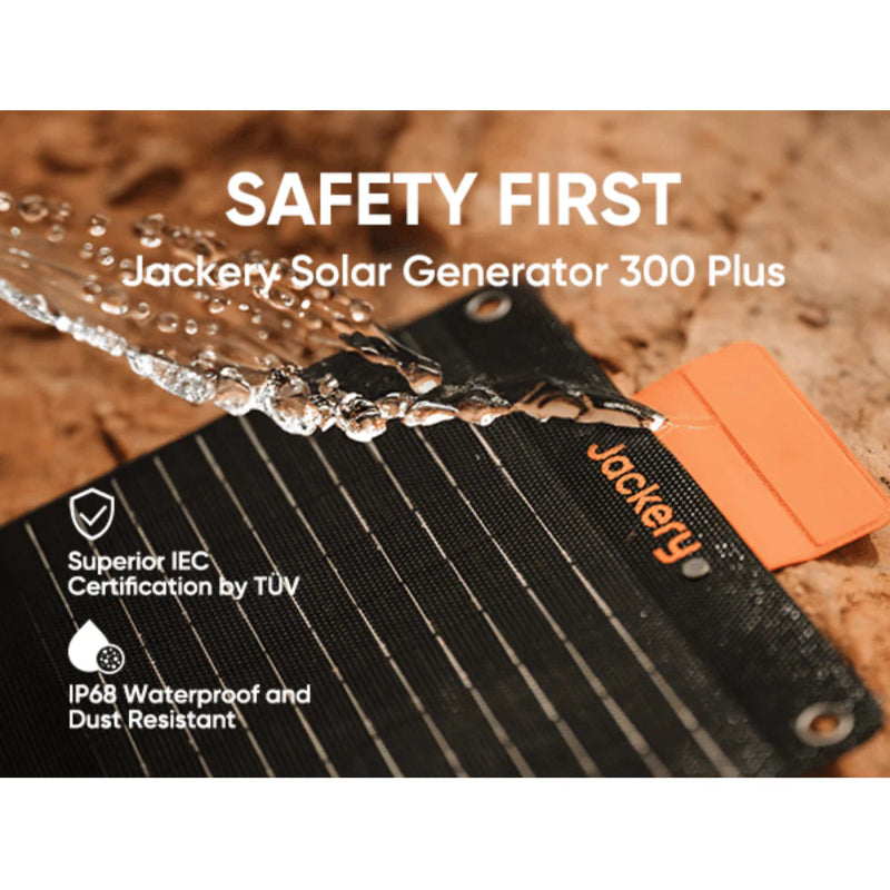 Image of a Jackery foldable solar panel demonstrating waterproof durability, black photovoltaic surface with orange accent and water splashing, close-up angled view on a rugged outdoor background.