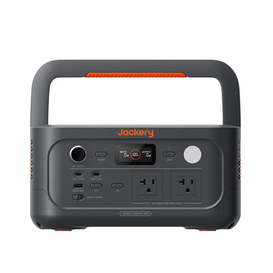 Image of a Jackery Explorer 600 portable power station with integrated handle, black and gray body with orange accents and front control panel, straight-on front view on white background.