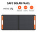 Image of Jackery SolarSaga 100W portable solar panel fully unfolded, black foldable panel with orange side handles and safety feature icons displayed, straight-on front view on white background.