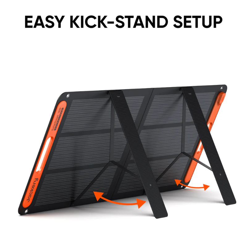 Image of Jackery SolarSaga 100W portable solar panel showing easy kick-stand setup, black foldable panel with orange side handles and rear support legs deployed, angled rear and side view on white background.