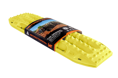 Image of blaze yellow Maxtrax recovery board, wrapped with its product packaging displaying branding and an off-road vehicle, angled on a light gray background.