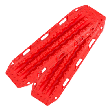 Image of red off-road recovery traction boards with raised cleats and built-in handles, stacked in an angled front and side view on black background.