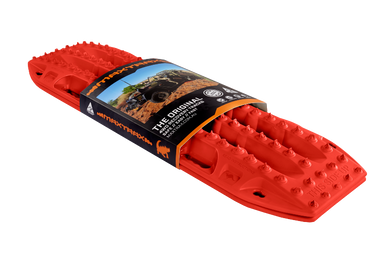 Image of red MAXTRAX MKII recovery traction boards with retail sleeve packaging, angled front and side view on black background.