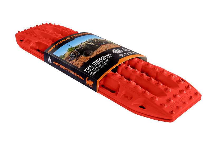 Image of red MAXTRAX MKII recovery traction boards with retail sleeve packaging, angled front and side view on black background.