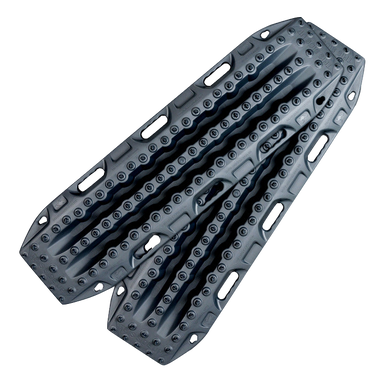 Image of gray off-road recovery traction boards with raised cleats and integrated handles, stacked in an angled front view on black background.