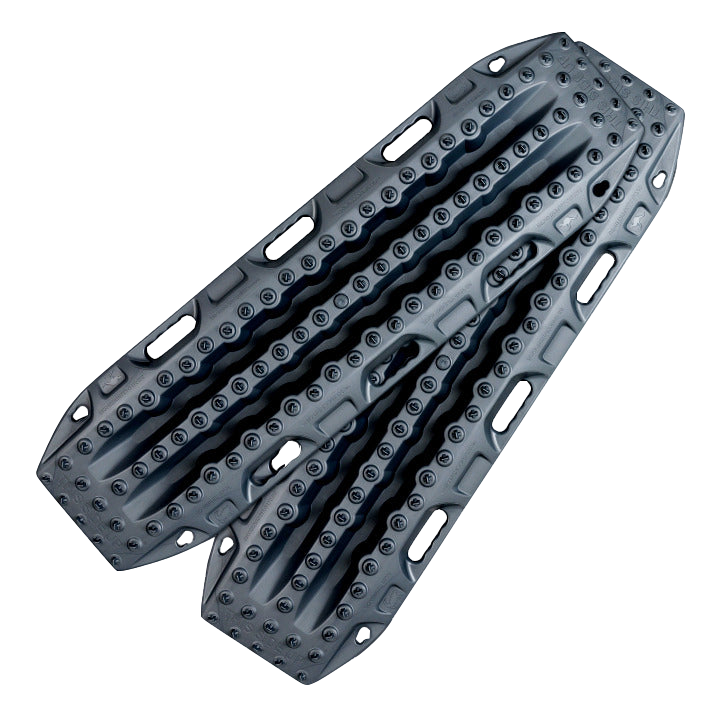 Image of gray off-road recovery traction boards with raised cleats and integrated handles, stacked in an angled front view on black background.