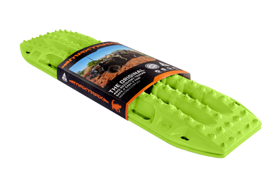 Image of a lime green Maxtrax recovery board, wrapped with its product packaging displaying branding and an off-road vehicle, angled on a light gray background.