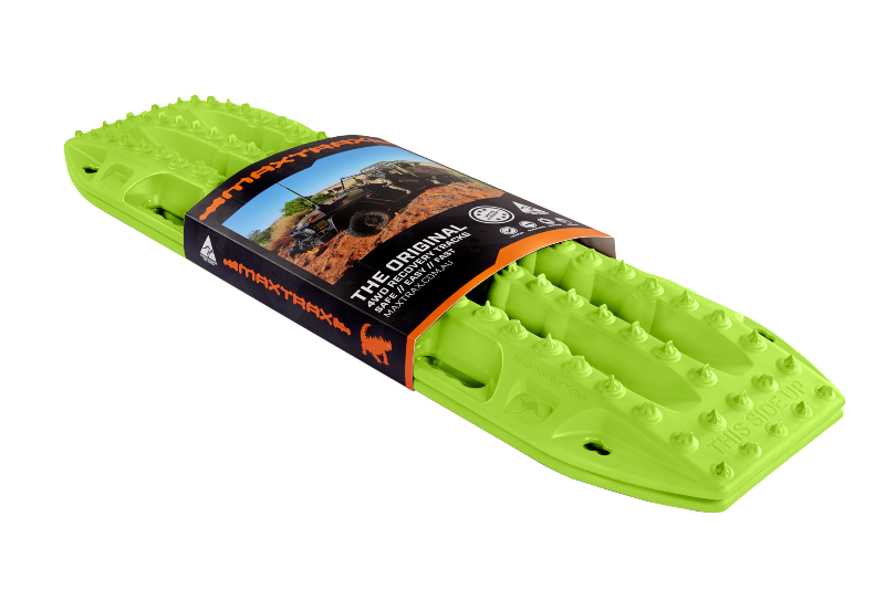 Image of a lime green Maxtrax recovery board, wrapped with its product packaging displaying branding and an off-road vehicle, angled on a light gray background.