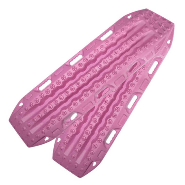 Image of pink off-road recovery traction boards with raised cleats and built-in handles, stacked in an angled front and side view on black background.