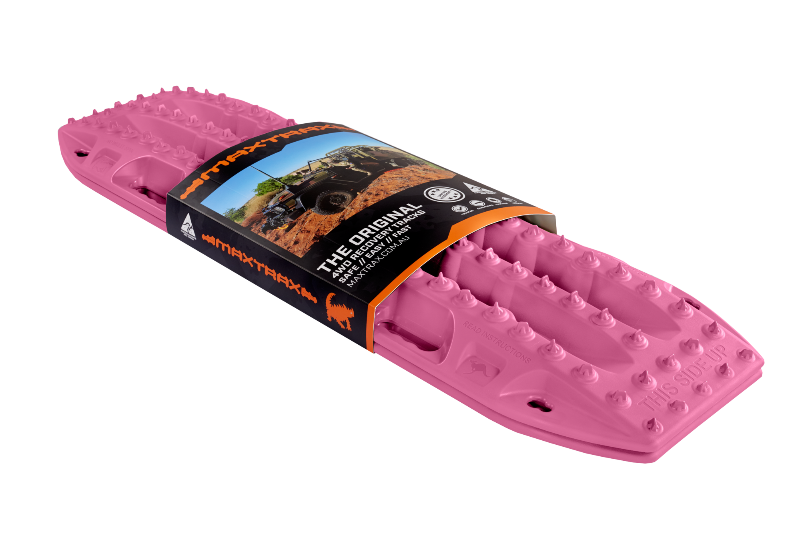 Image of pink MAXTRAX MKII recovery traction boards with retail sleeve packaging, angled front and side view on black background.