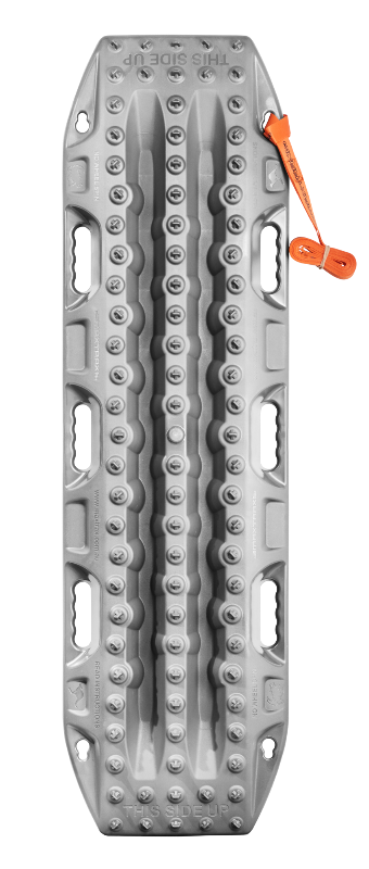 Image of a single gray traction recovery board with a textured, studded surface and multiple handles, designed for off-road vehicle recovery. An orange securing strap is visible near the top of the board.