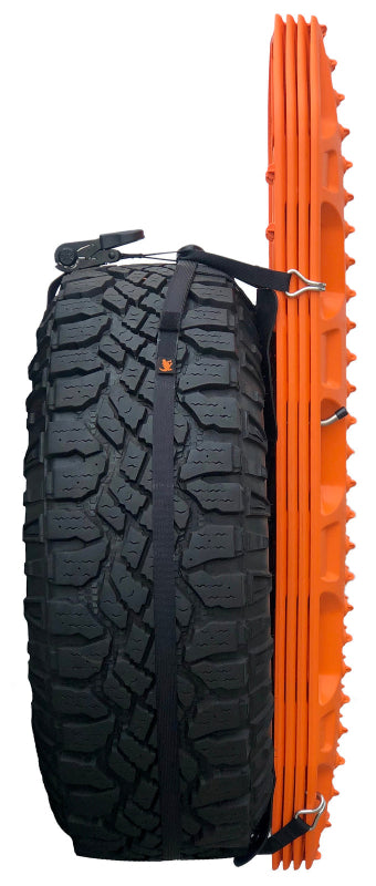 Orange MAXTRAX MKII recovery tracks mounted to a spare tire on a white background, secured with black straps.