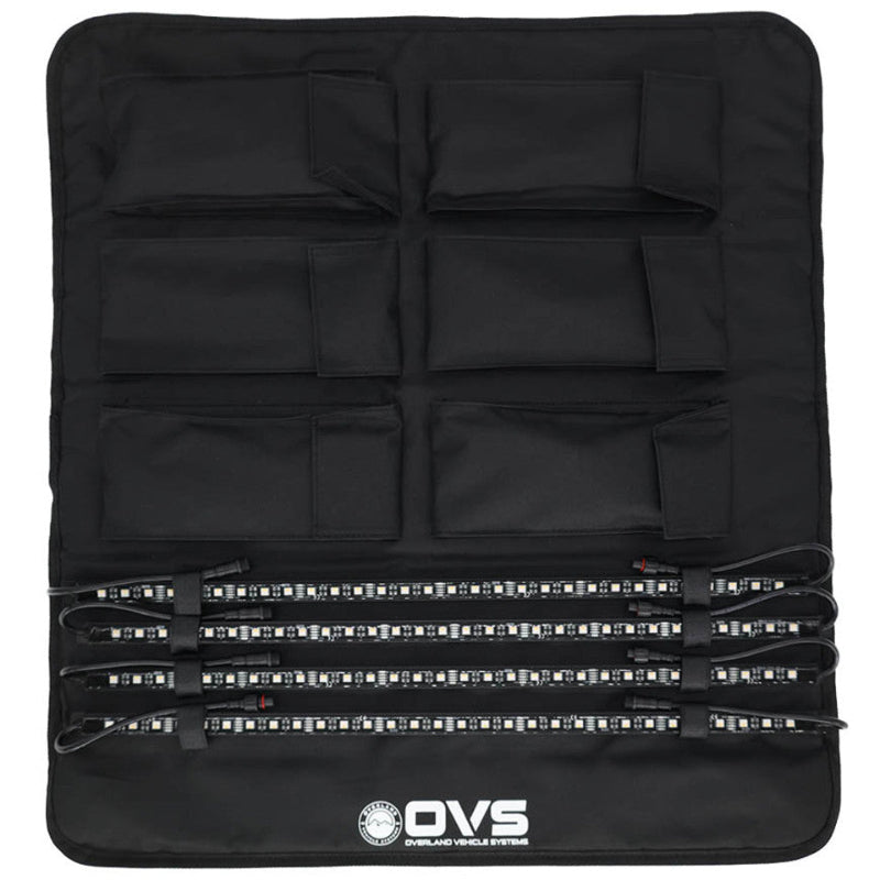 Image of OVS 4-piece universal LED light kit organized in a black roll-up storage panel with multiple pockets and secured LED light bars, top-down view on a white background.