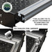 Image of Overland Vehicle Systems truck bed extension featuring T-rail system for adjusting tie-down rings, with 304 stainless steel hardware and diamond plate surface, close-up view with text highlighting features